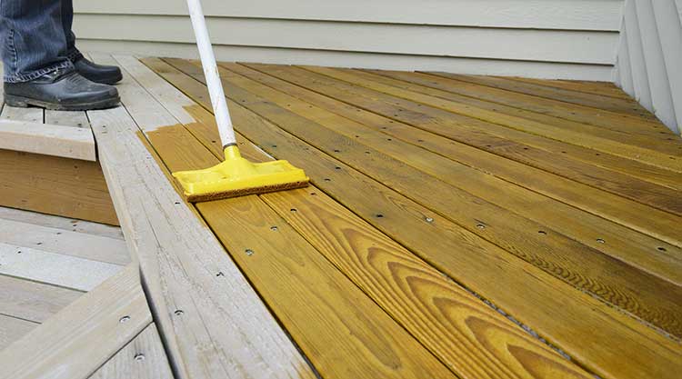 Deck Stain Being Applied to Deck Boards